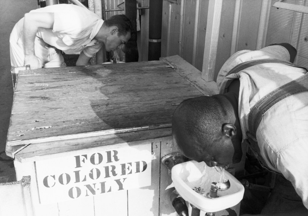 Men Drinking from Segregated Water Fountains