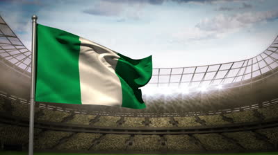 stock-footage-nigeria-flag-waving-on-flagpole-in-football-stadium-with-flashes