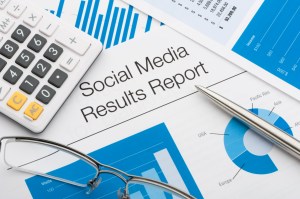 Close up of a social media results report with pen and calculator