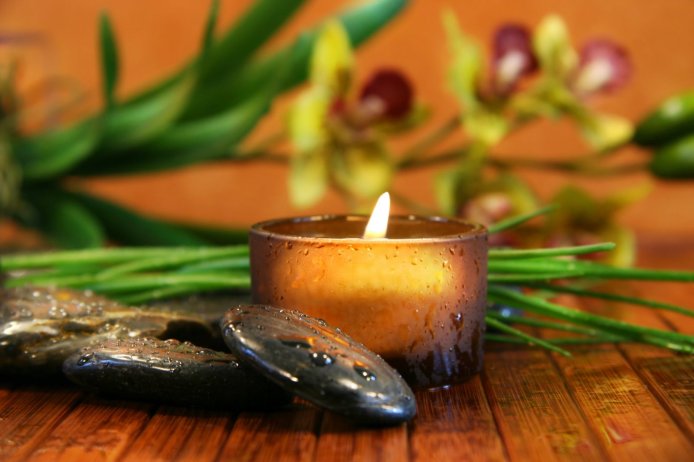 Image Source: Amber candle and spa stones with orchid on bamboo